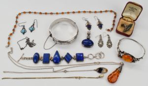 A collection of silver jewellery including bangles, one set with pressed amber, bracelet and pendant
