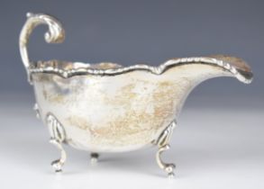 Irish George V hallmarked silver gravy or sauce boat with beaded edge, raised on three feet,