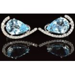 A pair of 18k white gold earrings set with a pear cut topaz surrounded by diamonds, 6.8g