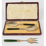 Cased pair of New Zealand Greenstone handled silver jam spoons, marked to bowls sterling and with