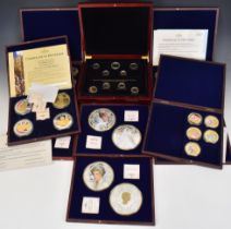 Nine wooden cased sets / part sets of collectible coins including jumbo editions, enamelled coins
