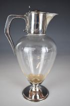 Edward VII hallmarked silver mounted glass claret jug with hinged lid engraved with crest for the