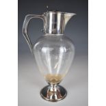 Edward VII hallmarked silver mounted glass claret jug with hinged lid engraved with crest for the