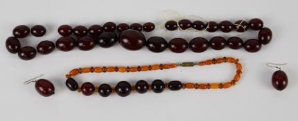 An amber necklace made up of cherry, Baltic and translucent beads, a graduated cherry amber necklace