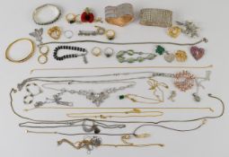 A collection of costume and silver jewellery including chains, brooches, silver rings, two Swarovski