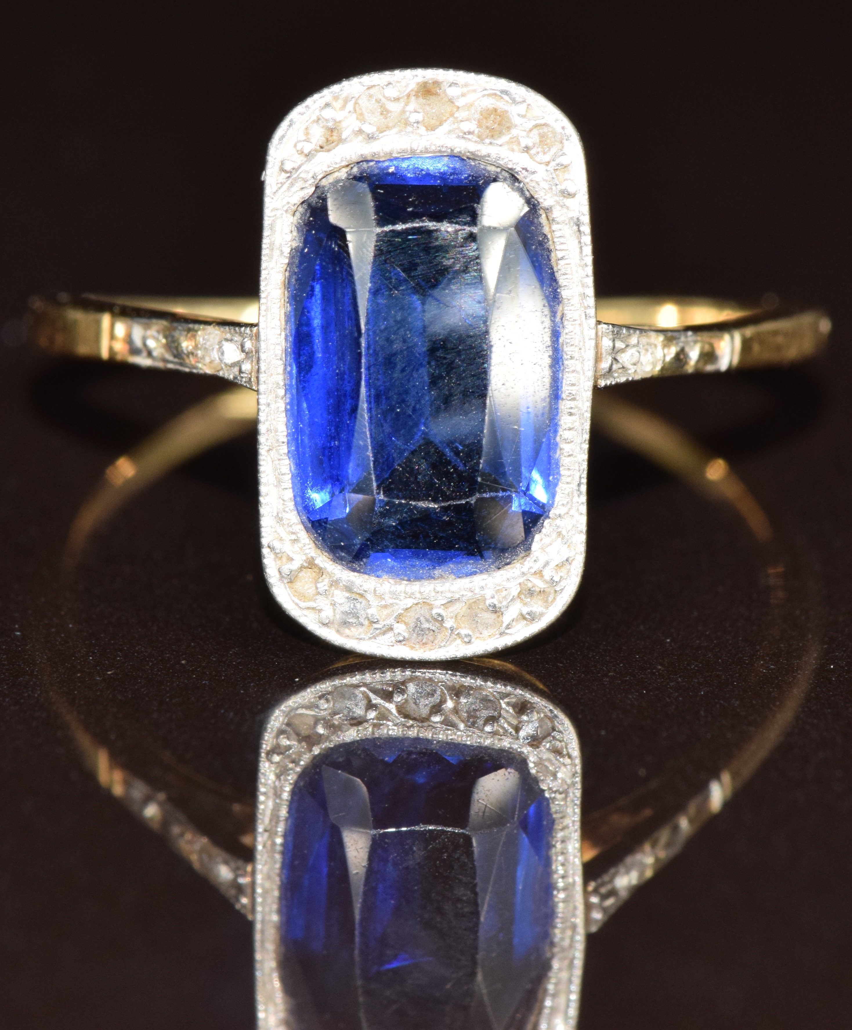 Art Deco 18ct gold ring set with a cushion cut synthetic sapphire and diamonds in a platinum