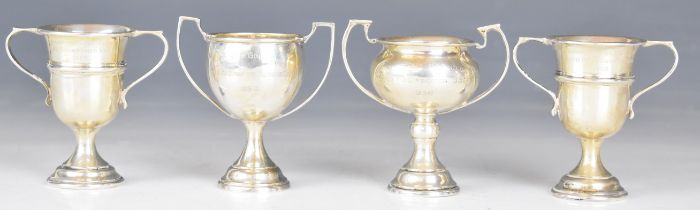 Four small Goldsmiths & Silversmiths Co Ltd hallmarked silver twin handled trophy cups, all engraved