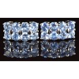 A pair of 18k white gold earrings each set with eight round cut Ceylon sapphires, the total sapphire