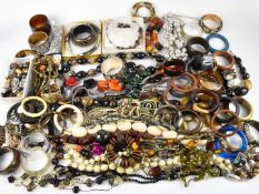 Collection of costume jewellery including large beaded necklaces, large bangles, earrings, brooch by