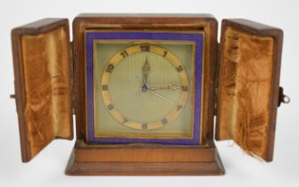 Art Deco travelling alarm clock with blue Greek key border and brass chapter ring to the engine
