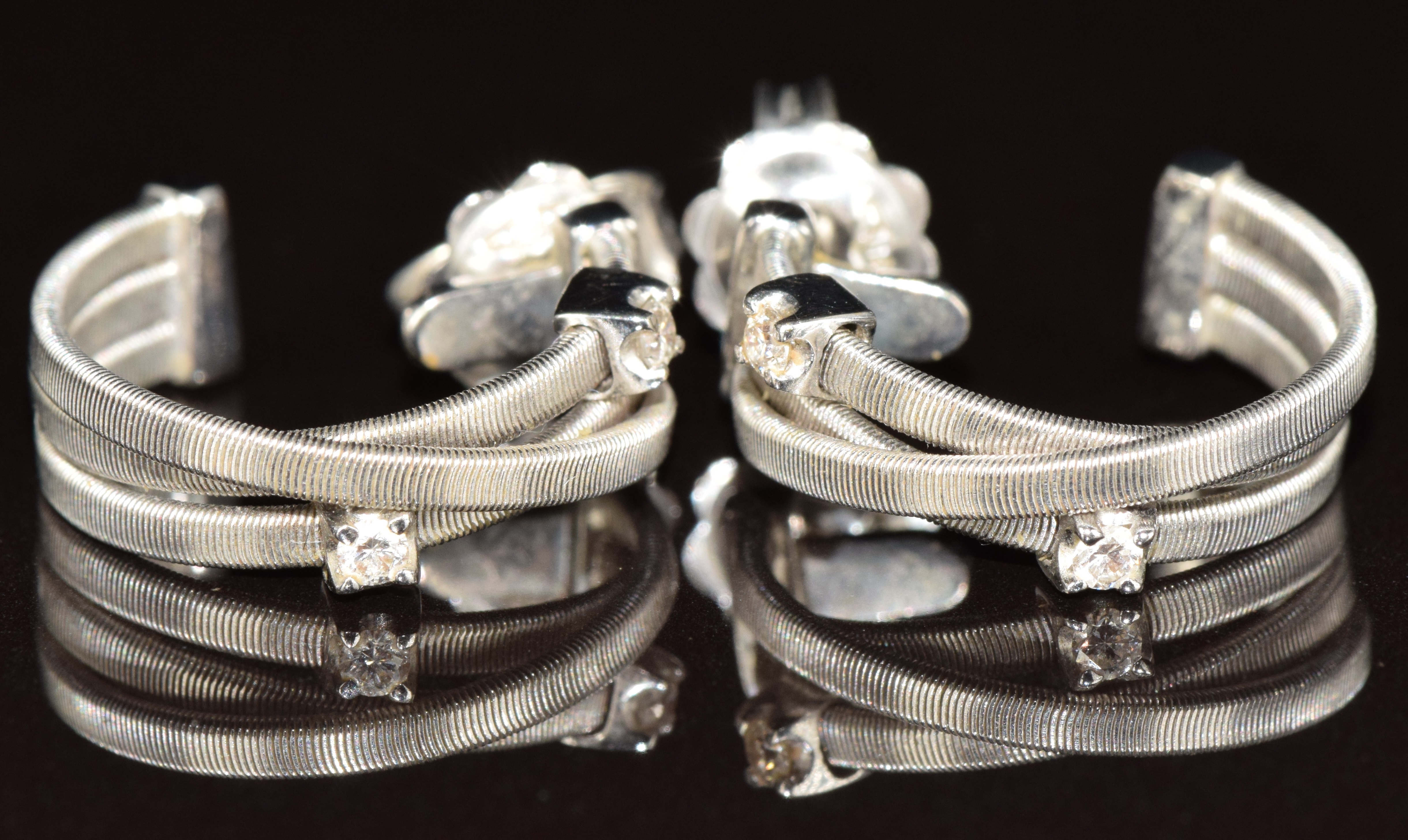 A pair of 18ct white gold earrings by Marco Bicego, each set with two diamonds, 6g