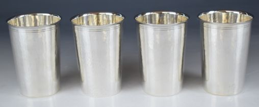 Set of Four Asprey Elizabeth II hallmarked silver beakers with Arts & Crafts style hammered