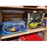 A Solido Porsche 911 GT3 Red Bull Racing; together with two Burago cars, all boxed. (3)