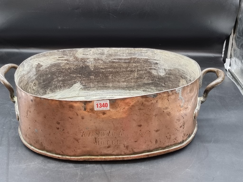 A large Victorian copper twin handled pan or kettle, inscribed 'Keswick Hotel Co', 57cm wide.