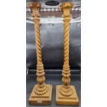 A large and impressive pair of carved giltwood lamp stands, (formally electrified), 88cm high.