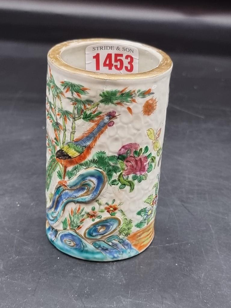 A Chinese famille rose sleeve vase or brush pot, late 19th century, relief decorated on a textured