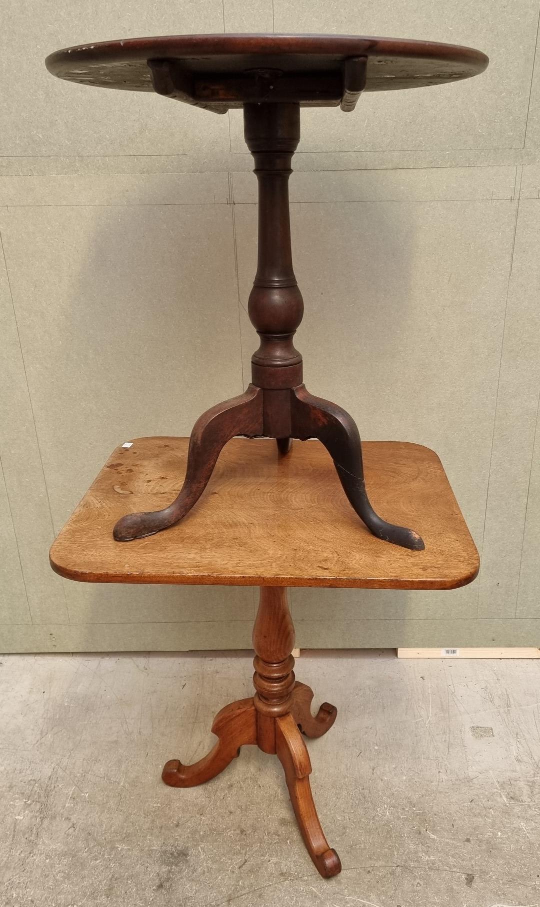 Two mahogany tilt-top tripod tables, comprising: a George III circular example, 60cm diameter; and a