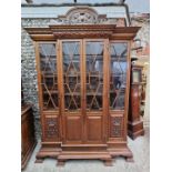 A large circa 1900 carved oak breakfront bookcase, 257.5cm high x 183.5cm wide x 54cm at deepest