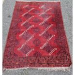 A Tribal rug, on a red ground, 168cm x 120cm.