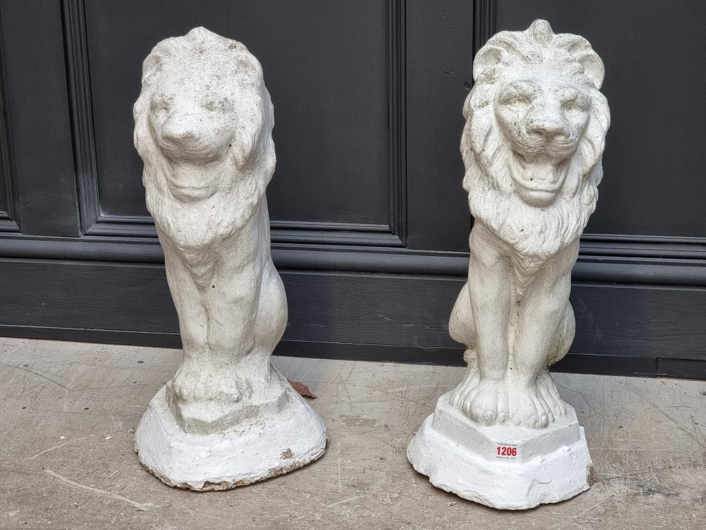 A pair of white painted composition stone lion gate pier finials, 56cm high.