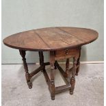 A small early 18th century oak gateleg table, with frieze drawer, 93cm wide when open.
