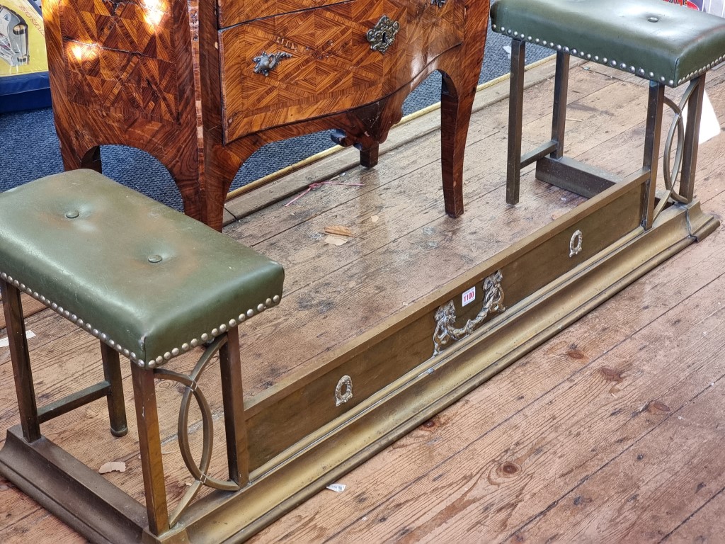 A late Victorian brass and studded green leather club fender, 40cm high x 134cm wide x 37cm deep.