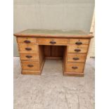 An antique pitch pine pedestal desk, 122cm wide.