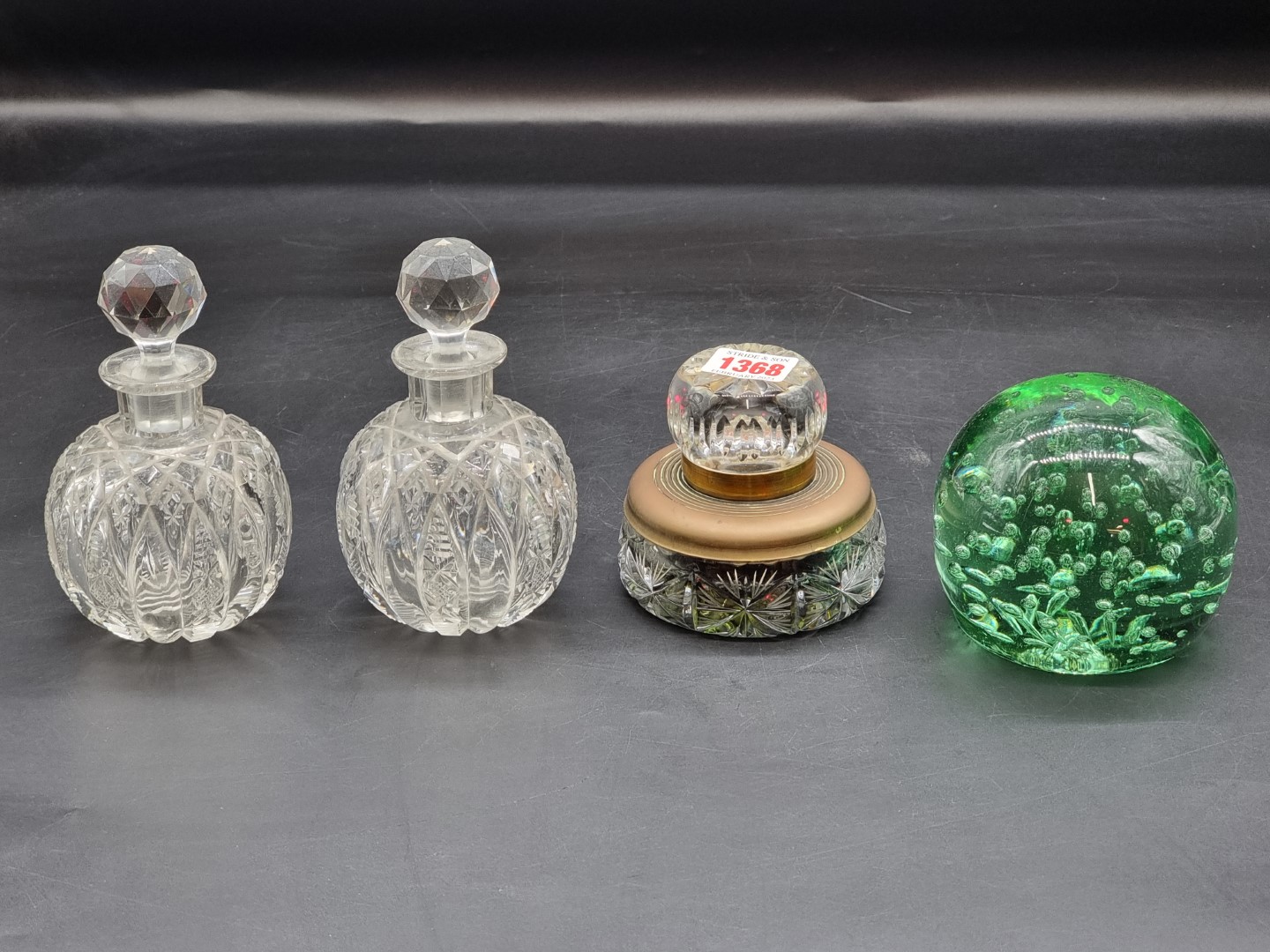 A pair of cut glass inkwells and stoppers, 14cm high; together with a green glass dump