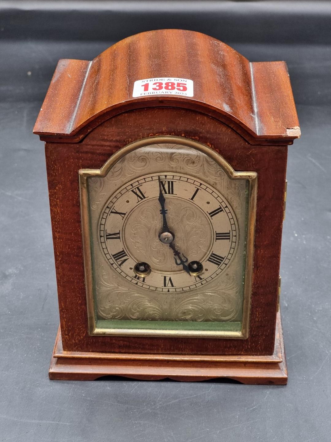 An early 20th century mahogany dome top mantel clock, with silvered dial, 18.5cm high, (chip to