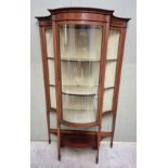 An Edwardian mahogany and inlaid serpentine display cabinet, 106cm wide.