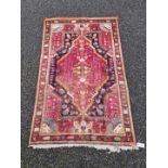 A Persian rug, central field decorated with flowers, 161 x 100cm; together with a small Persian rug,