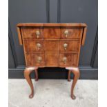 A 1930s figured walnut and crossbanded three drawer side table, with drop leaves and serpentine