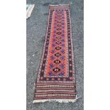A Persian runner, having repeated design to central field, with star borders, 285 x 65cm.