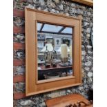 A contemporary pale oak rectangular framed wall mirror, 80 x 65cm.