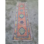 A Persian runner, having five central medallions, with geometric borders, 270 x 84cm.
