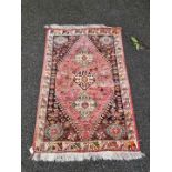 A Persian rug, having three central medallions, floral cartouches to each corner with animals to