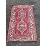 A Persian rug, having two medallions, with floral borders, 160 x 105cm.