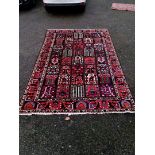 A Persian carpet, having gul design to central field, with tree decoration, floral borders, 300 x