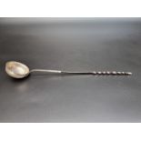 An antique white metal toddy ladle, having twisted baleen handle, 35cm.
