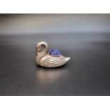 A Chinese white metal swan pin cushion, stamped marks to base, 6.5cm long.