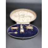 A cased silver three piece cruet set, by E S Barnsley & Co, Birmingham 1920, 104g.