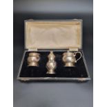 A cased silver three piece cruet set by Adie Bros Ltd, Birmingham 1956, 145g.