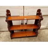 A late 19th/early 20th century mahogany fretwork hanging three tier shelf, 62cm wide.