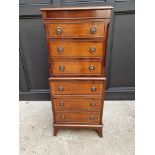 A small reproduction mahogany chest on chest, 48cm wide.