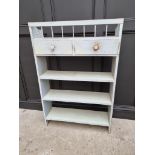 An old blue painted open bookcase, 130cm high x 87cm wide.