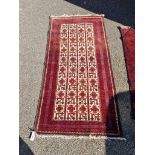 A Persian rug, having repeated geometric design to central field, with geometric borders, 186 x