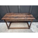 A late 17th century oak rectangular table, with carved frieze to one long side and peripheral