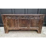 A 17th century oak panelled coffer, with unusual carved frieze, 138cm wide.