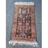 A Persian rug, having temple design to central field, with floral borders, 145 x 79cm.