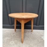 An antique pine cricket table, 81.5cm diameter.